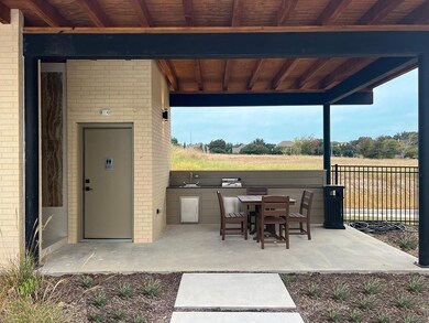 View of patio with a rural view and exterior kitch