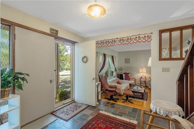 From the foyer you can go left into the sunken living room, straight to the stairs to the second level or into the formal dining room, or right into the kitchen. We will head left into the living room.