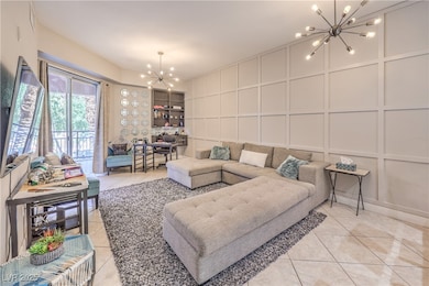 Living area featuring a chandelier, a decorative w