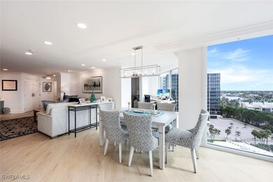 Dining area featuring crown molding, an inviting chandelier, and light wood-type flooring