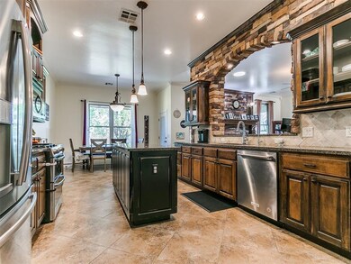 Kitchen featuring ornamental molding, hanging ligh