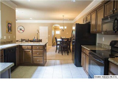 Kitchen opens into dining room and family room. Ti