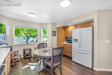 Dining area with baseboards and wood finished floors