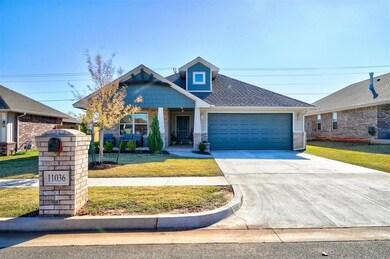 Craftsman house with a front lawn and a garage