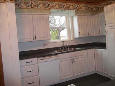 Kitchen. WHITE CABINETRY WITH LAMINATE COUNTERTOPS