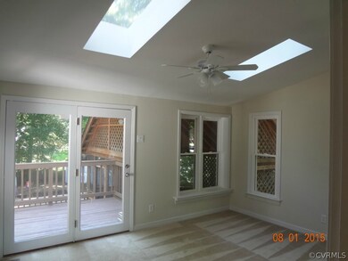 Florida room with ceiling fan, skylights