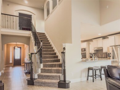 Elegant staircase with  soaring ceilings and light