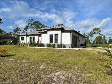Prairie-style house featuring metal roof, an attac