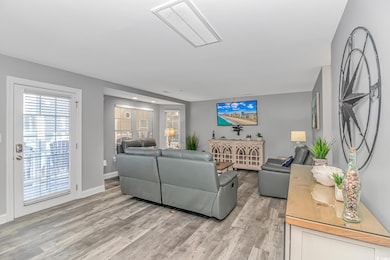 Living room with light hardwood / wood-style floor