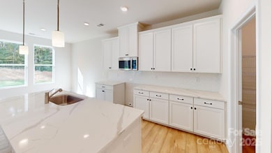 Kitchen - Photo is representative of a previous home built