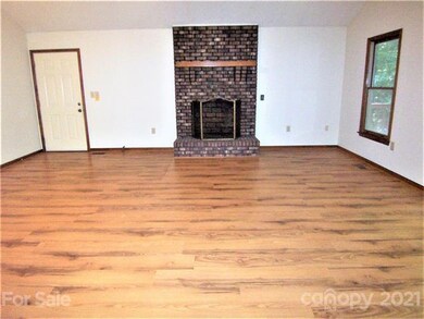 Living Room/Dining Room has a brick fireplace which is plumbed for gas logs. (Per the homeowner, the gas logs are in the storage building.)