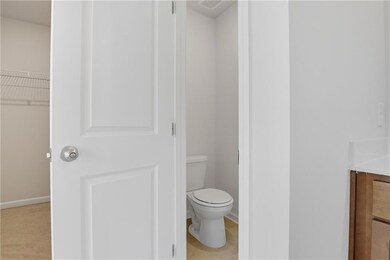Bathroom with vanity, a walk in closet, and light tile patterned floors