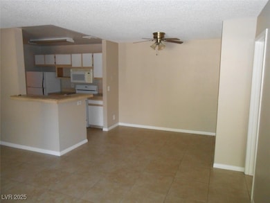 Kitchen with a textured ceiling, baseboards, ceili