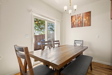 Dining space with a notable chandelier, baseboard