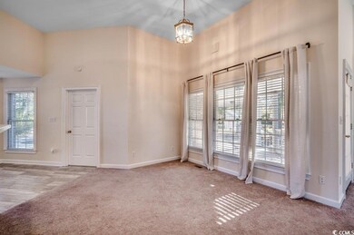 Interior space with a towering ceiling, light colo