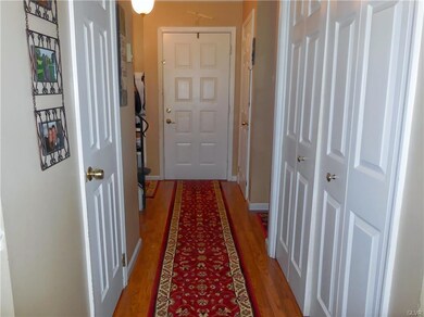 inviting foyer with multiple closets, powder room,
