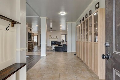 Foyer entrance featuring decorative columns, a cei