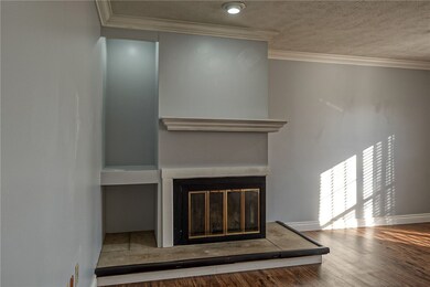 Fireplace with mantle with recessed lighting.