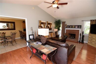 The living room is a lovely place to entertain and features a vaulted ceiling and wood burning fireplace. Warm oak hardwood and tile floors throughout home.