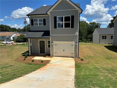 View of front of house featuring concrete driveway, a garage, a front lawn, and a shingled roof
