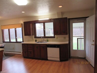 Back door in kitchen leads to covered porch.