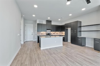 Kitchen featuring modern cabinets, light countert