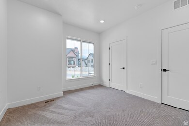 Unfurnished bedroom with carpet and recessed lighting