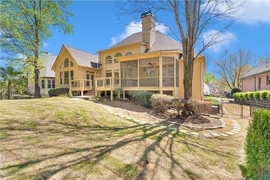 Rear view of property featuring a wooden deck, a y