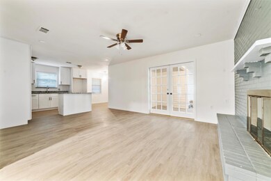Unfurnished living room with french doors, sink, l