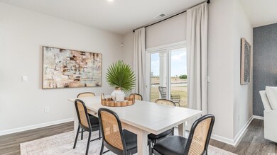 Dining room with wood finished floors, baseboards, and recessed lighting