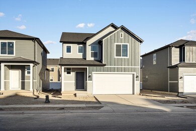 View of front of property with board and batten siding, concrete driveway, a garage, and roof with shingles