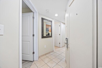 Hall featuring light tile patterned flooring