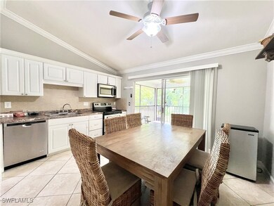 Tiled dining space featuring ceiling fan, sink, cr