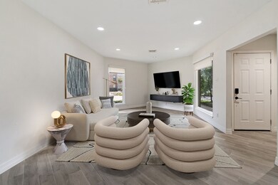 Living room has been virtually staged for visual reference.