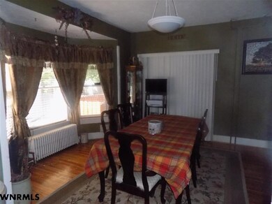 Formal Dining room features wood floors and a bay 