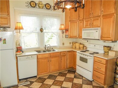 This great kitchen offers Beautiful Maple Cabinets, Tile Floors, Huge pantry and more. 