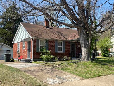View of front of house with a chimney, a shingled 