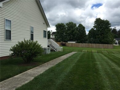 Seller added a concrete walkway for easy  access to the back deck area. Concrete also leads you right up to the  tastefully built ramp area to allow for ease of access to the deck area.