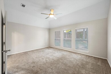 A spacious primary bedroom has ideal natural light