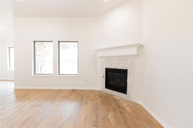 Unfurnished living room featuring a premium firepl
