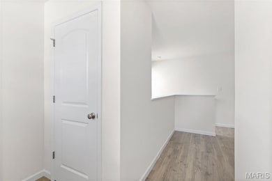 Hall featuring baseboards and light wood-style floors