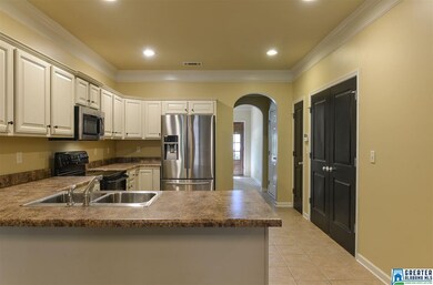 Stunning kitchen with arches, SS, and antique whit