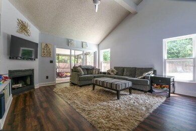 Living Room w/ Fireplace and Laminate Flooring