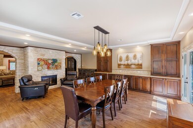Dining space featuring a fireplace, arched walkwa
