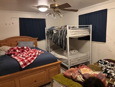 Bedroom featuring crown molding and a ceiling fan
