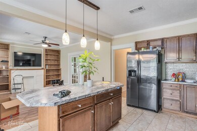 Kitchen featuring ceiling fan, pendant lighting, a