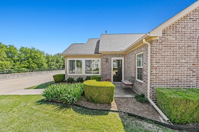 Flower beds, room for a bench, and storm door to w