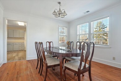 Dining space featuring ornamental molding, light h