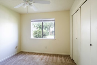 Unfurnished bedroom with a ceiling fan, baseboards