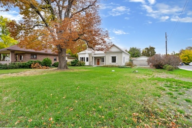 View of front of house with a front lawn and brick siding